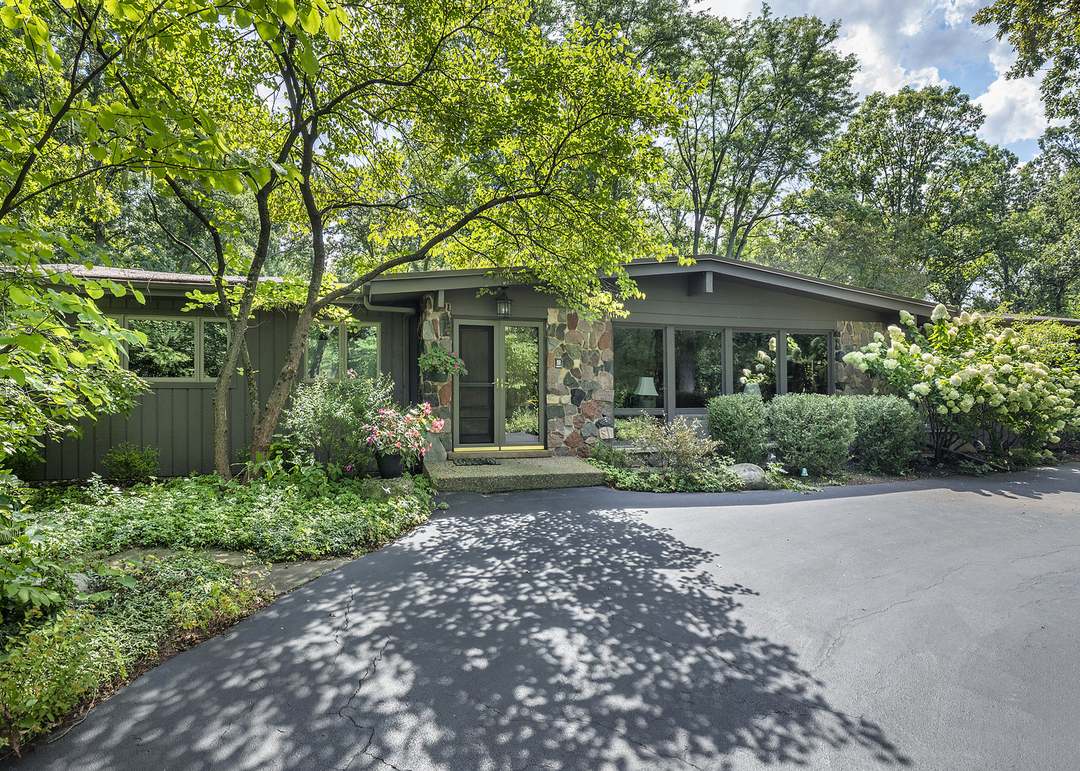 A mid-century home settled into its wooded lot